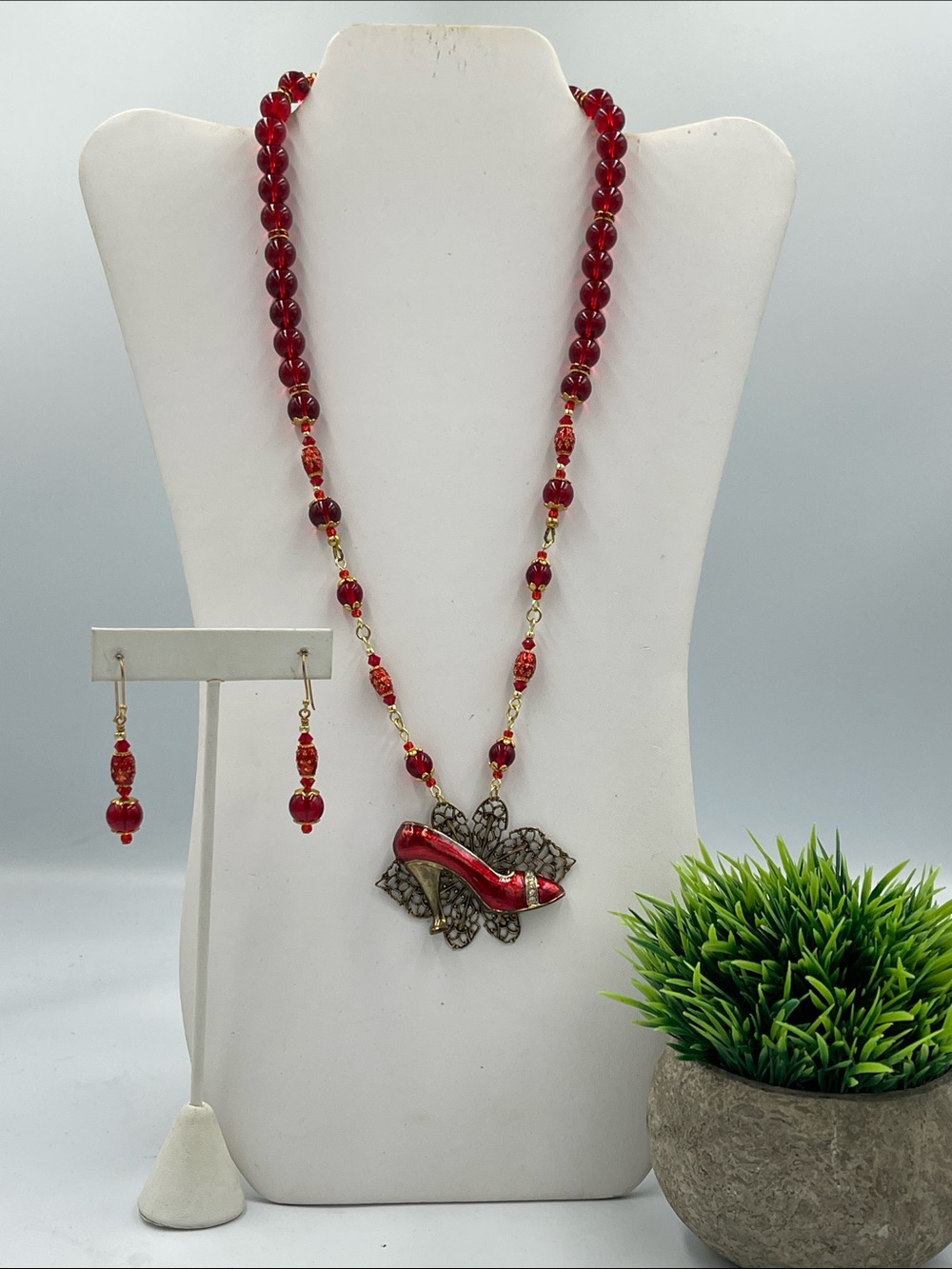 Red beaded rosary-style necklace and matching earring set. Red shoe. Custom.